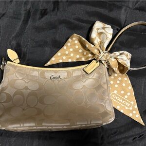 Coach, authentic store-front purchased shoulder bag and tie-on bow accessory.